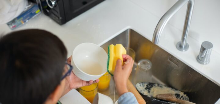 industrious boy cleaning the dishes